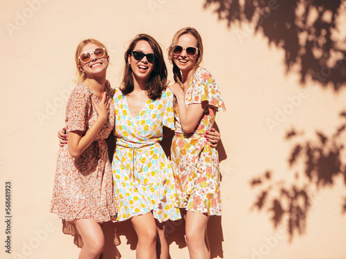 Fotografering Three young beautiful smiling hipster female in trendy summer dress clothes