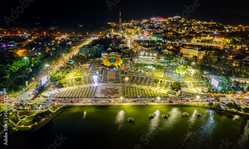 Aerial panorama view of Sunflower Building at night in Da Lat City. Tourist city in developed Vietnam. Center Square of Da Lat city with Xuan Huong lake.