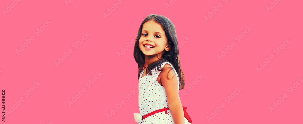 Portrait of cheerful smiling little girl child having fun wearing white dress on pink background Portrait of cheerful smiling little girl child having fun wearing white dress on pink background