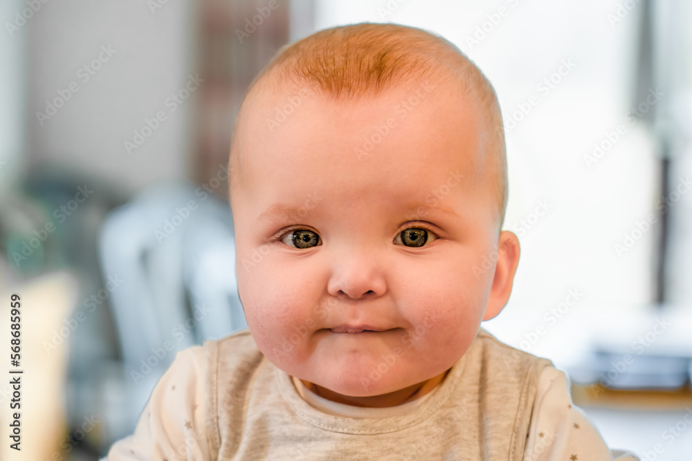 cute baby boy with blue eyes staring in to the camera cute baby boy with blue eyes staring in to the camera