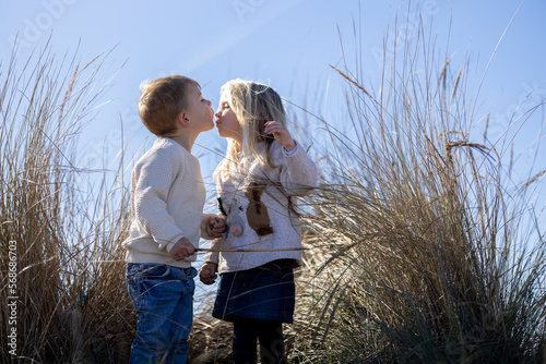 Blonde toddlers kissing each other