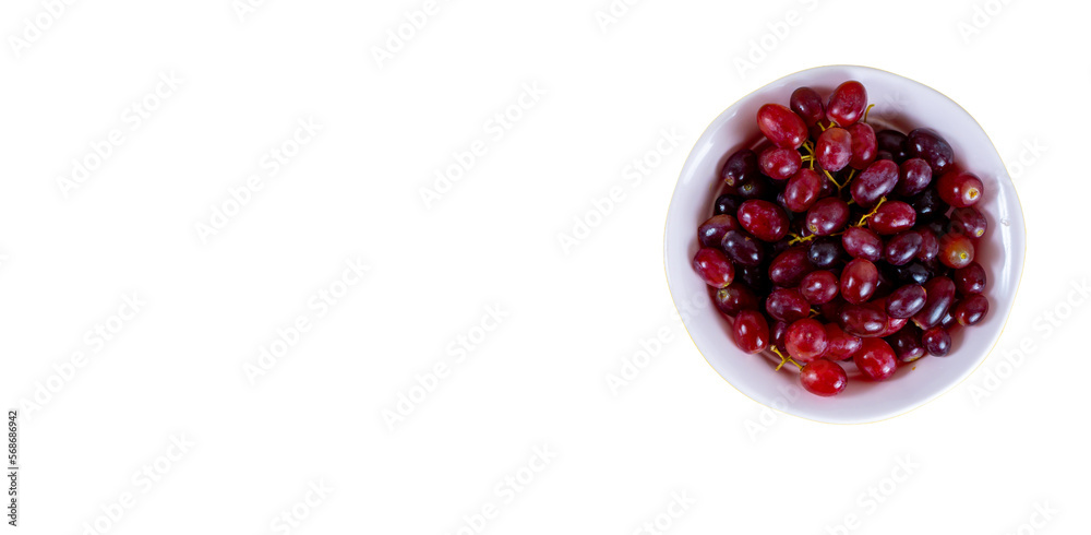 Red grape isolated on pink cup, white background Red grape isolated on pink cup, white background