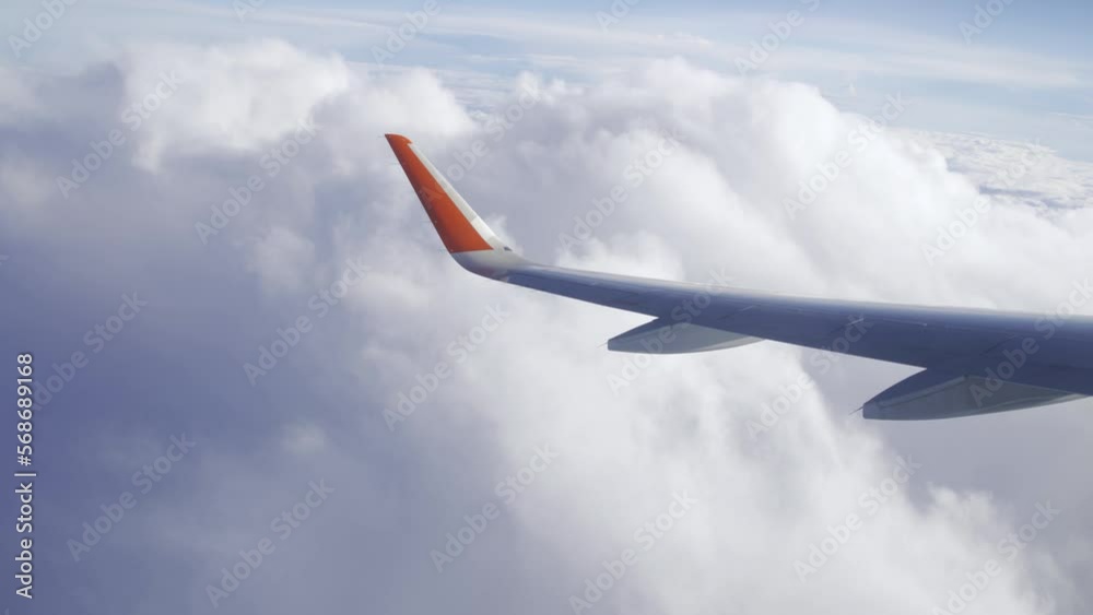 Flying in a plane through the fluffy, snow-white clouds. Spectacular view from the window of an airplane. Aircraft flies into a cluster of beautiful clouds. Ultra HD stock footage Flying in a plane through the fluffy, snow-white clouds. Spectacular view from the window of an airplane. Aircraft flies into a cluster of beautiful clouds. Ultra HD stock footage