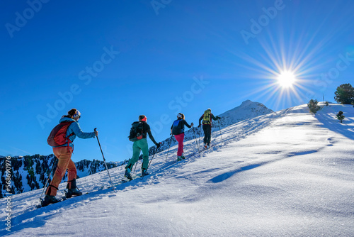 Austria, Tyrol, Group of skiers traveling in row acrossGrosser Galtenberg photo