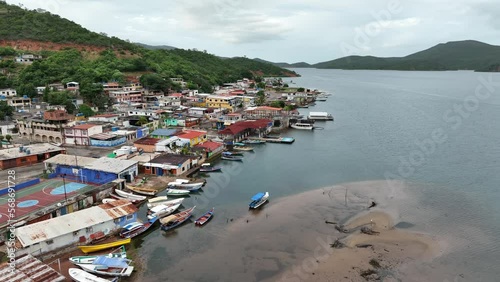 Camera slowly moving along the waterfront of small Venezuelan town Mochima in Mochima National Park, Venezuela. photo