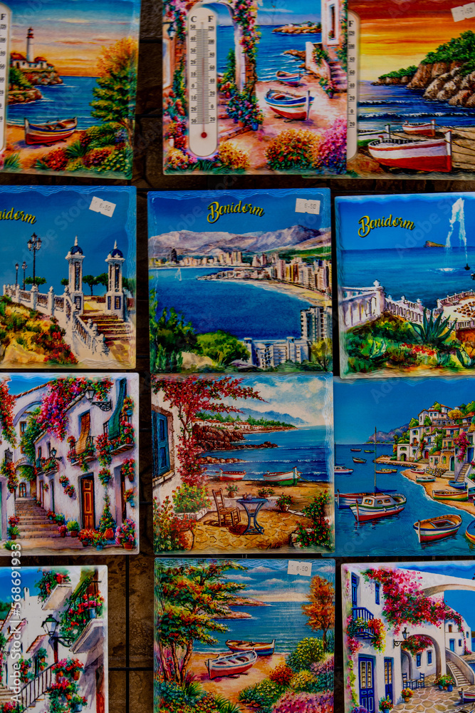 ceramic tiles souvenirs in a shop in the south of spain in a tourist town, colorful art crafts background