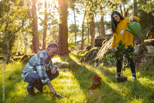 Mature couple caring for natural garden