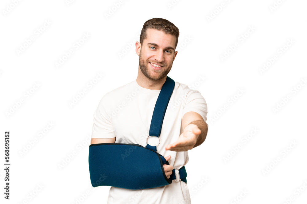 Young handsome blonde man with broken arm and wearing a sling over isolated chroma key background shaking hands for closing a good deal Young handsome blonde man with broken arm and wearing a sling over isolated chroma key background shaking hands for closing a good deal