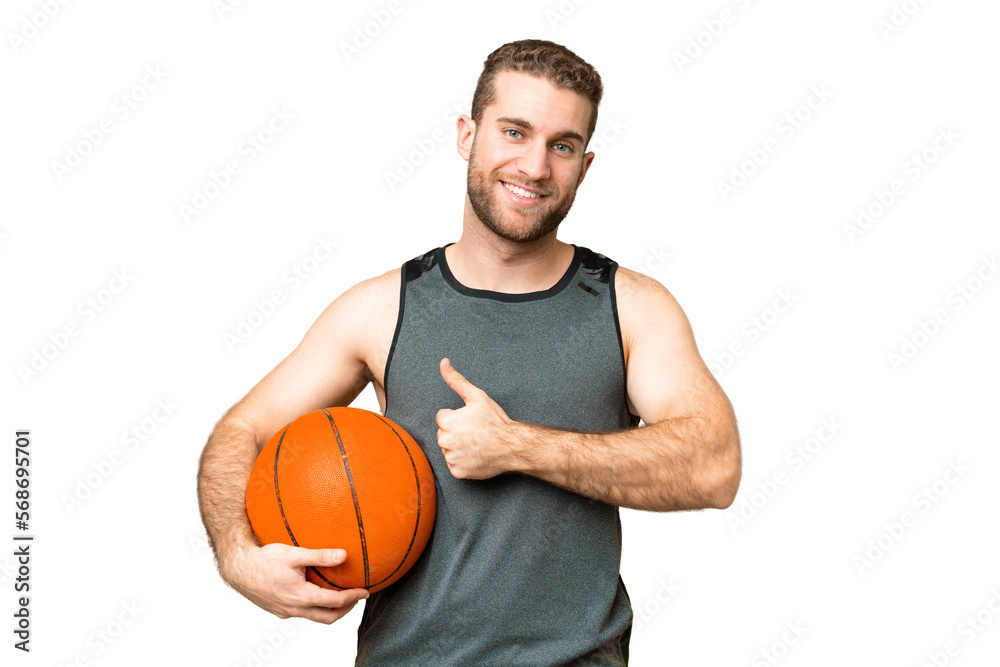 Handsome young man playing basketball over isolated chroma key background giving a thumbs up gesture Handsome young man playing basketball over isolated chroma key background giving a thumbs up gesture
