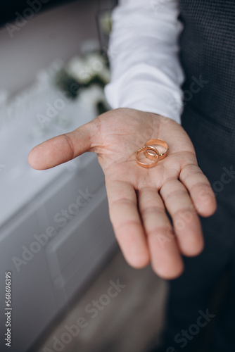 wedding rings on the palm, groom's preparations, preparation of wedding rings for the holiday, photo details, jewelry that symbolizes the marriage bond, a long tradition.