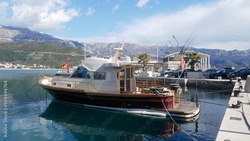 White yacht at the pier. Yacht on the seashore. Recreation boat. Boat for a sea trip.