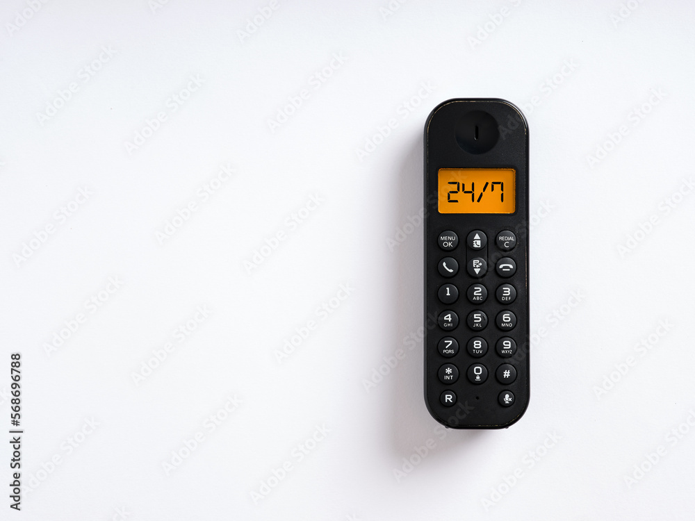 The word 24/7 written on the screen of a wireless phone. Call center assistance, service support, customer care concept. The word 24/7 written on the screen of a wireless phone. Call center assistance, service support, customer care concept.