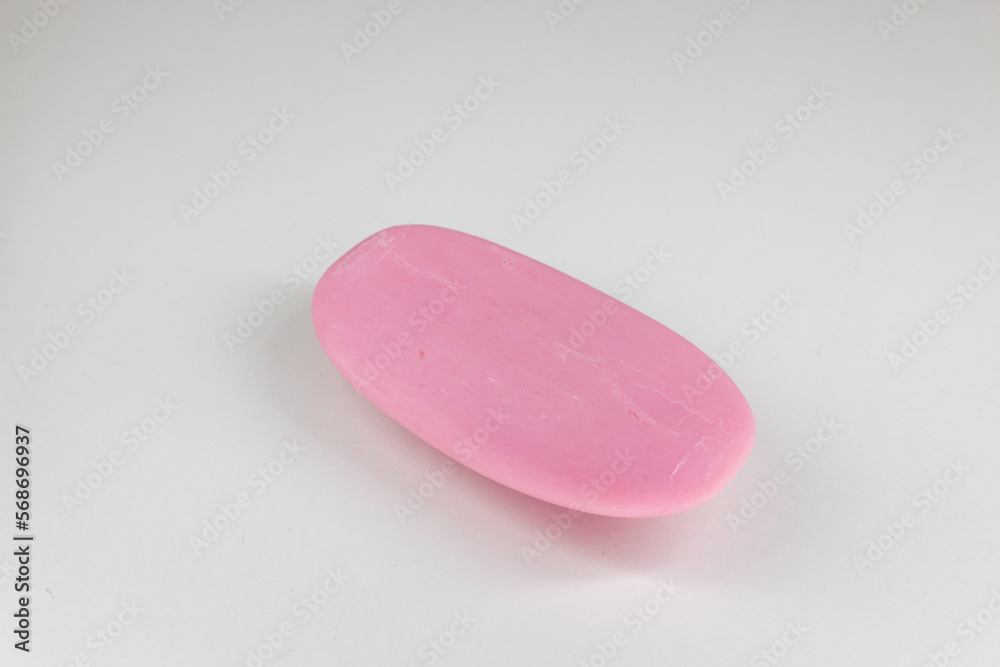 A piece of pink soap on a white background. Isolated. A piece of pink soap on a white background. Isolated.