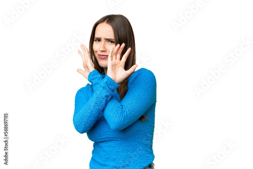 Young beautiful woman over isolated chroma key background nervous stretching hands to the front