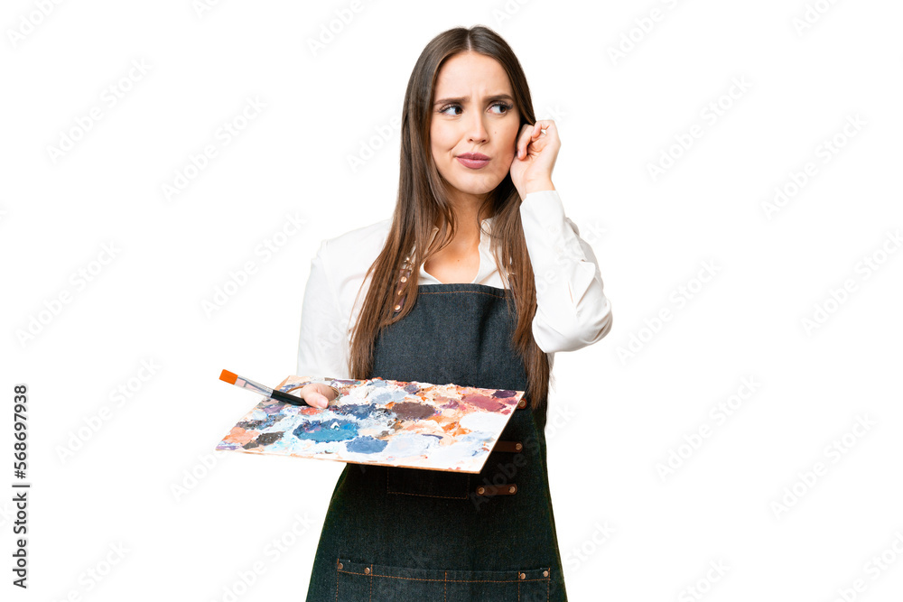 Young artist woman holding a palette over isolated chroma key background frustrated and covering ears Young artist woman holding a palette over isolated chroma key background frustrated and covering ears