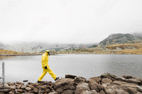 Person wearing  yellow hazmat suit during Covid 19 pandemic photo