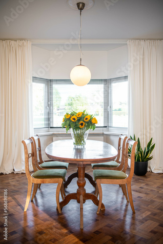 a dining table with sunflowers photo