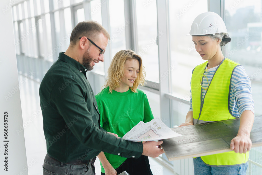 Businessman meeting with employee and engineer on office floor