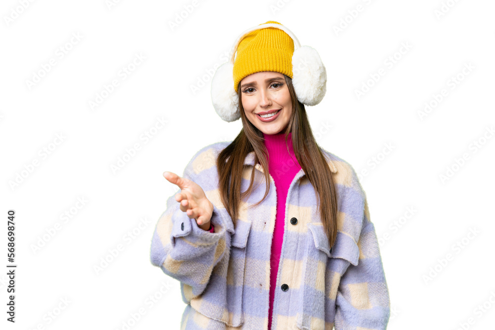 Young woman wearing winter muffs over isolated chroma key background shaking hands for closing a good deal Young woman wearing winter muffs over isolated chroma key background shaking hands for closing a good deal