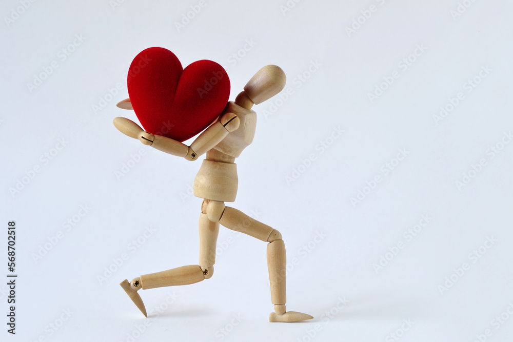 Wooden mannequin carrying heavy heart on his back - Concept of love, effort and heavy burden - obrazy, fototapety, plakaty 