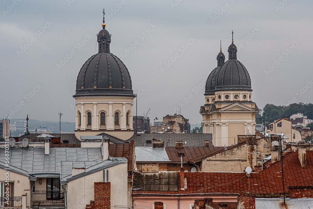 Landscape of ancient church domes in the centre  of Lviv (Lwow, Lvov), Ukraine, on overcast rainy day, scenic view of roofs in old town, historical buildings from observation deck, touriust landmark