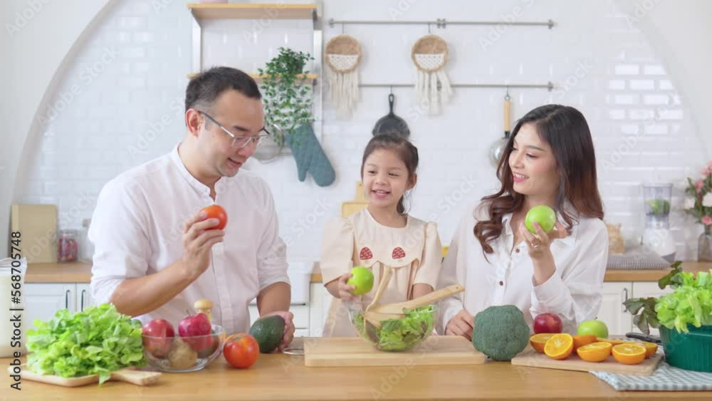 Happy family cooking together on kitchen. Home recreation and food preparation on weekend. Happy family cooking together on kitchen. Home recreation and food preparation on weekend.