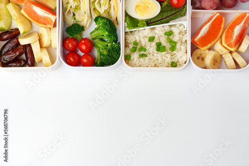 Lunch boxes with healthy food isolated on white