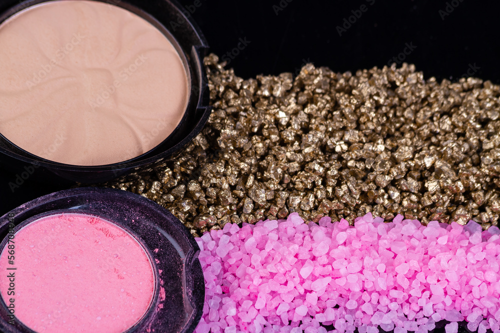 Top view two powder boxes and sea salt. Pink and golden himalayan salt