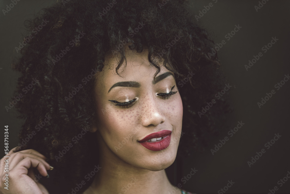 Beautiful afro-american girl with afro hairstyle and stylish clothing