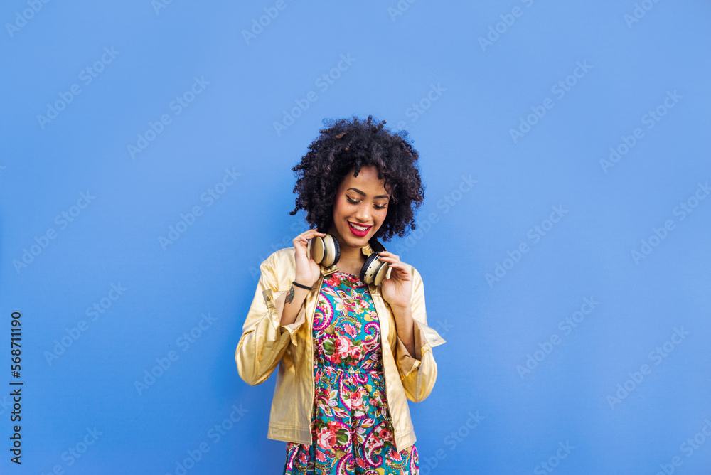 Beautiful black young woman with afro hair style and fashionable clothes strolling in the city Beautiful black young woman with afro hair style and fashionable clothes strolling in the city