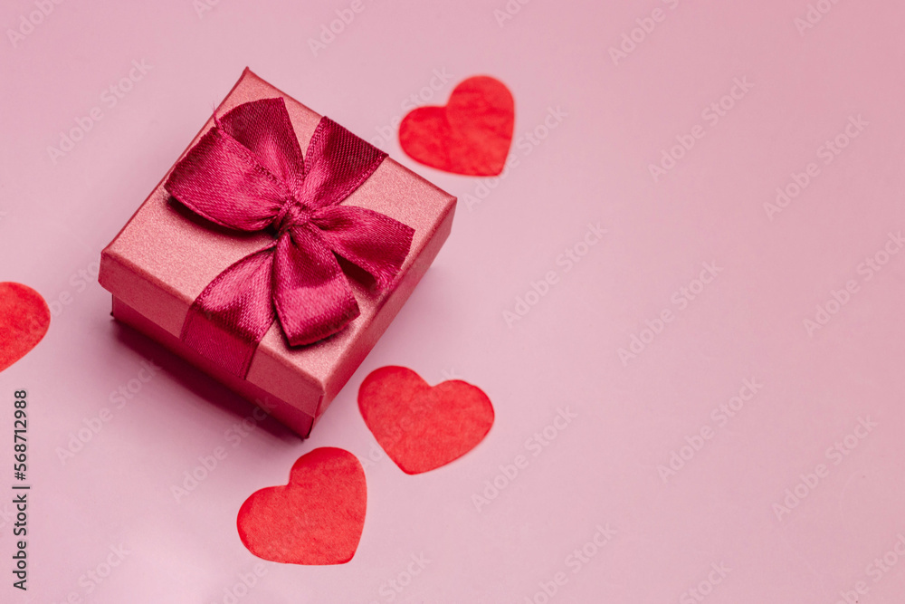 Paper art Valentine's day concept banner with hand made gift box, paper cut ribbon, bow, and a lot of hearts on a red background with space for text. Paper art Valentine's day concept banner with hand made gift box, paper cut ribbon, bow, and a lot of hearts on a red background with space for text.