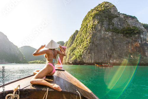 Beautiful woman on a long-tail boat in Thailand - Tourist visiting tropical island on south-east Asia, concepts about lifestyle and travel