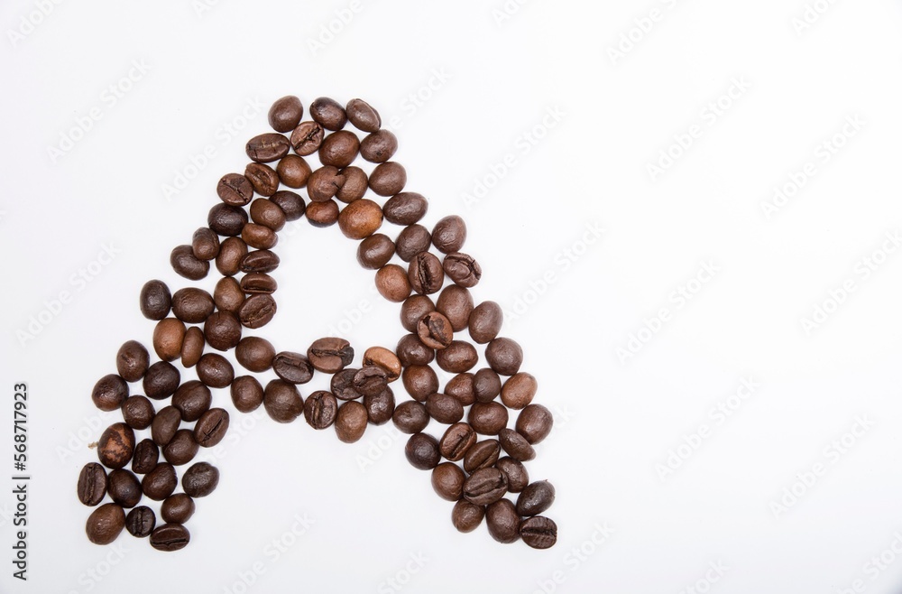 A is a capital letter of the English alphabet made up of natural roasted coffee beans that lie on a white background. Plenty of space to put text or pictures, top view and studio photography. A is a capital letter of the English alphabet made up of natural roasted coffee beans that lie on a white background. Plenty of space to put text or pictures, top view and studio photography.