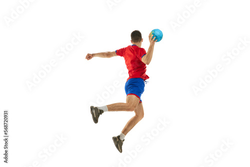 Side view. Dynamic studio shot of professional male handball player in motion training, playing isolated on white studio background. Concept of sport, action, motion, championship, sportive lifestyle