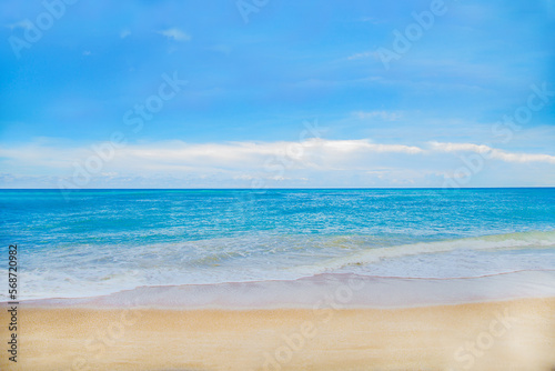 Beach with blue sea water and blue sky
