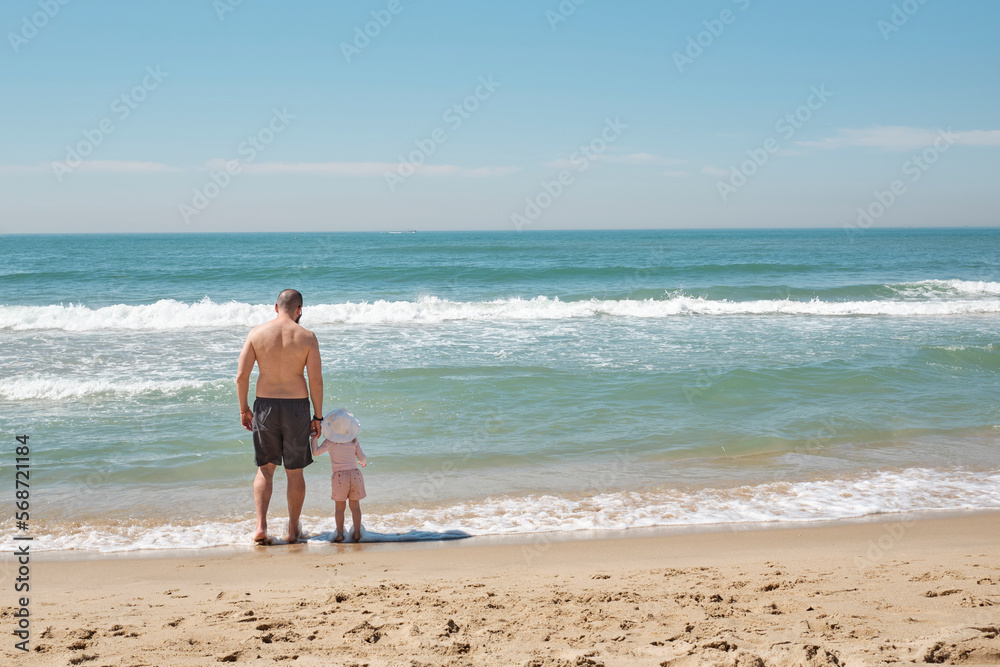 Father with toddler daughter enjoying a beach in South Korea