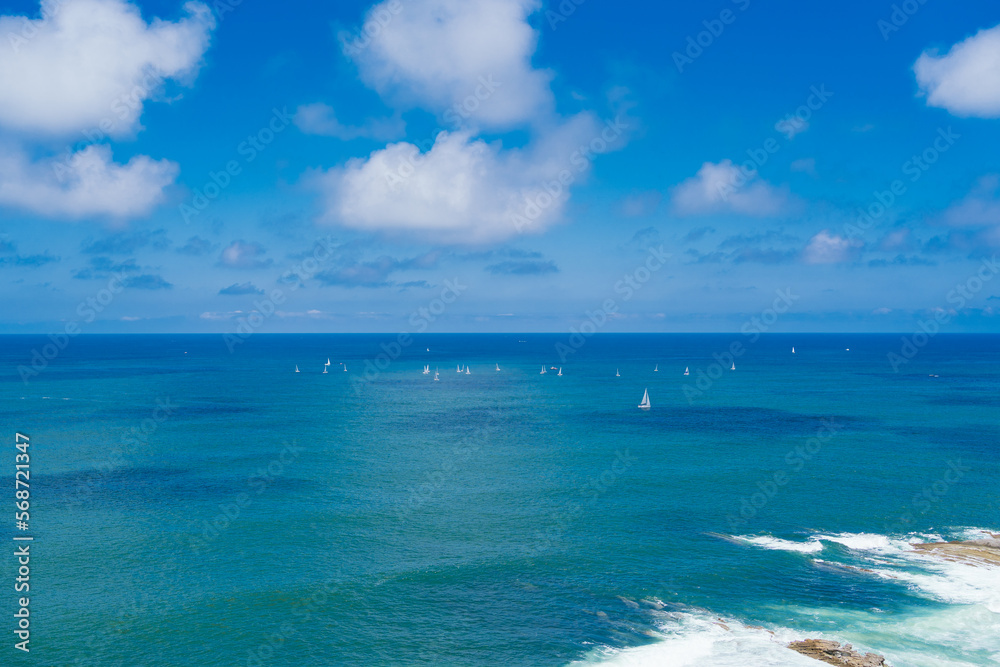 pleasure sailboats sailing the blue sea