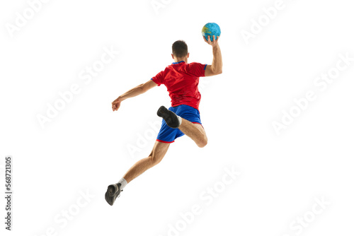 Back view studio shot of young man, professional handball player training, playing isolated over white background. In motion. Concept of sport, action, motion, championship, sportive lifestyle