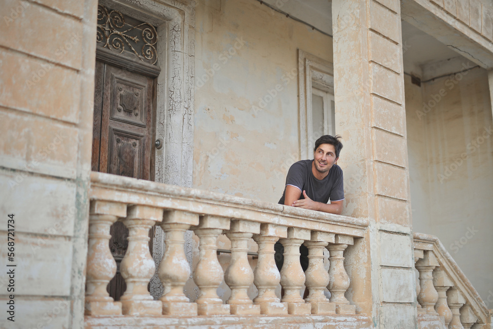 portrait of young man waiting for someone on the entrance of the portrait of young man waiting for someone on the entrance of the
