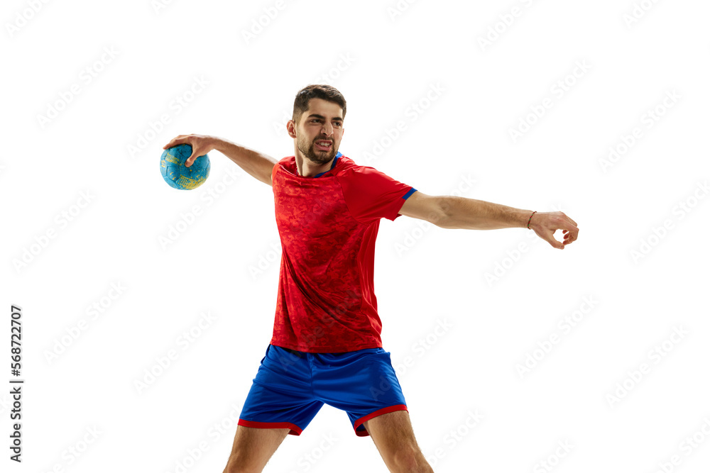 Motivation to win. Young man, professional handball player in red uniform playing, training isolated over white studio background. Concept of sport, action, motion, championship, sportive lifestyle Motivation to win. Young man, professional handball player in red uniform playing, training isolated over white studio background. Concept of sport, action, motion, championship, sportive lifestyle