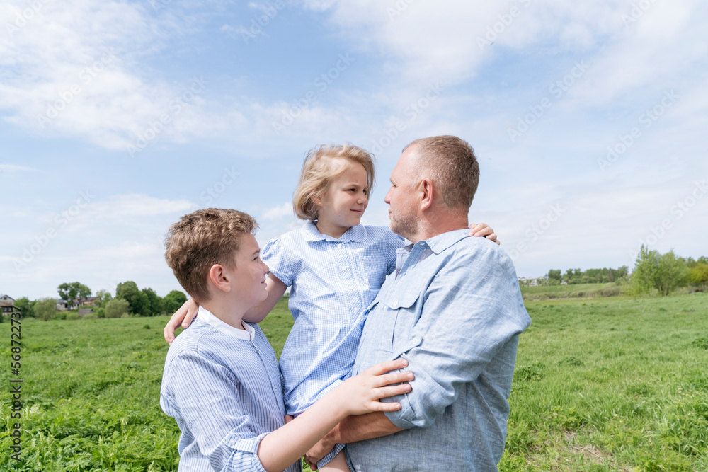 Mature man walking in nature with two children. Mature man walking in nature with two children.