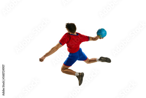 Goal. Back view studio shot of young man, professional handball player training, playing isolated over white background. In motion. Concept of sport, action, motion, championship, sportive lifestyle