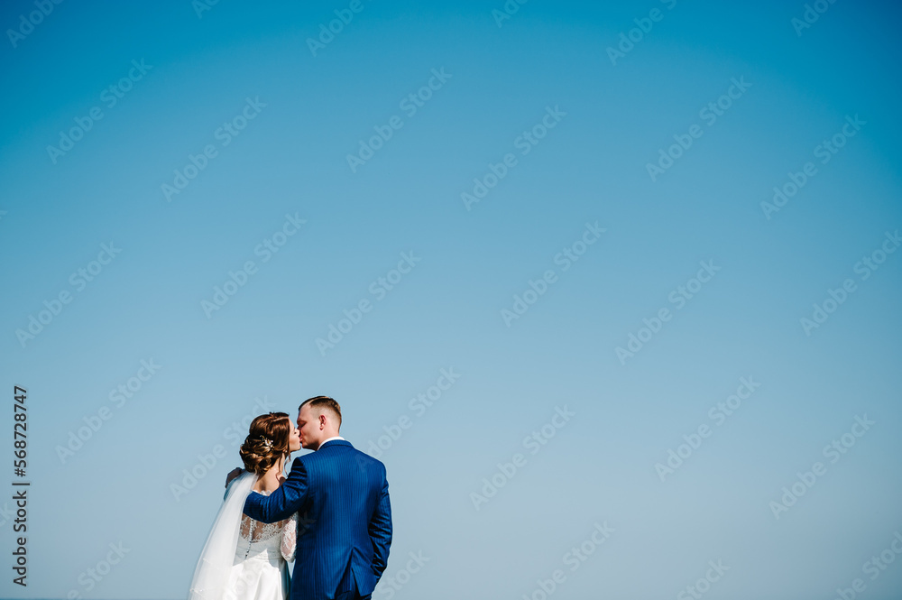 Bride and groom kissing. Couple newlyweds photo portrait. Wedding Couple in nature. Bride and groom kissing. Couple newlyweds photo portrait. Wedding Couple in nature.