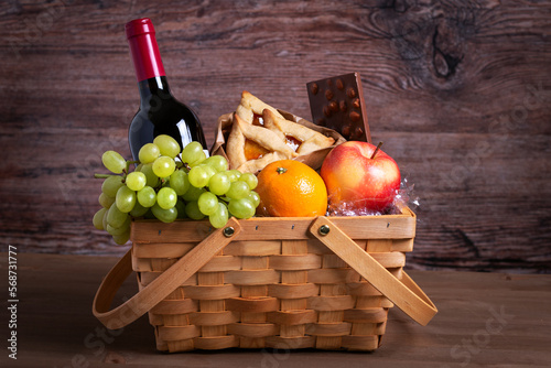 Purim basket with foods and wine on wooden table photo