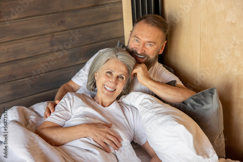 Mature couple staying in bed and feeling close and relaxed © zinkevych