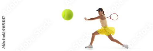 One young teen girl, tennis player in sports uniform playing tennis isolated over white background. Concept of sport, fashion, motivation, education and achievement