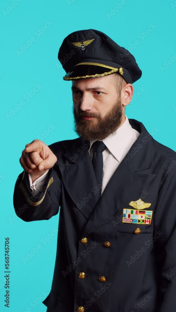 Vertical video: Plane captain in aviation uniform pointing at camera and choosing, saying i want you for commercial flights aircrew. Young male pilot flying airplane and acting confident, feeling Vertical video: Plane captain in aviation uniform pointing at camera and choosing, saying i want you for commercial flights aircrew. Young male pilot flying airplane and acting confident, feeling
