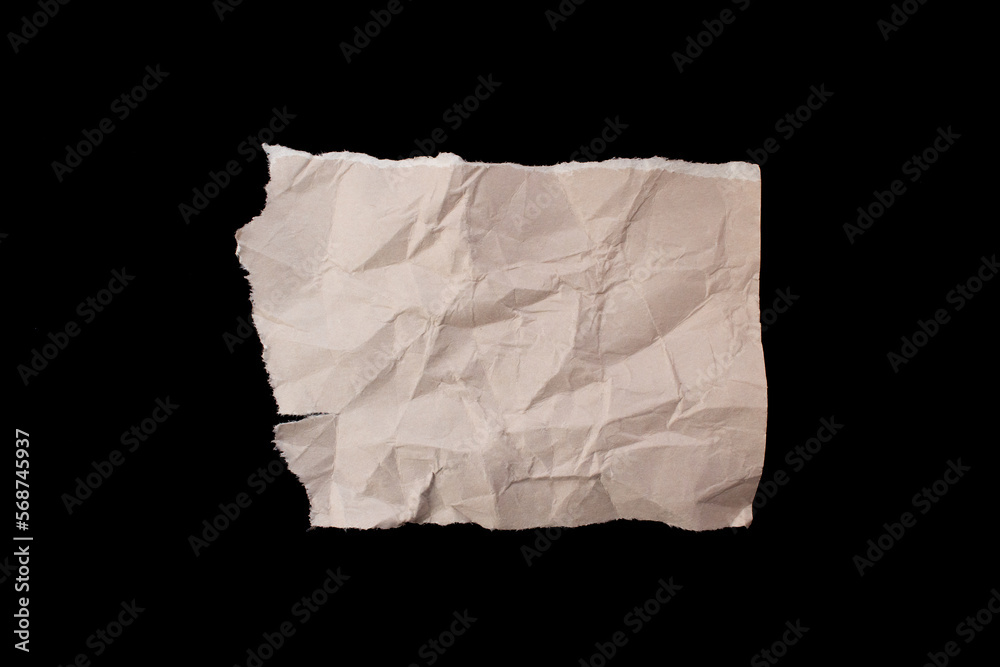 Fototapeta premium Crumpled torn paper piece isolated on black background