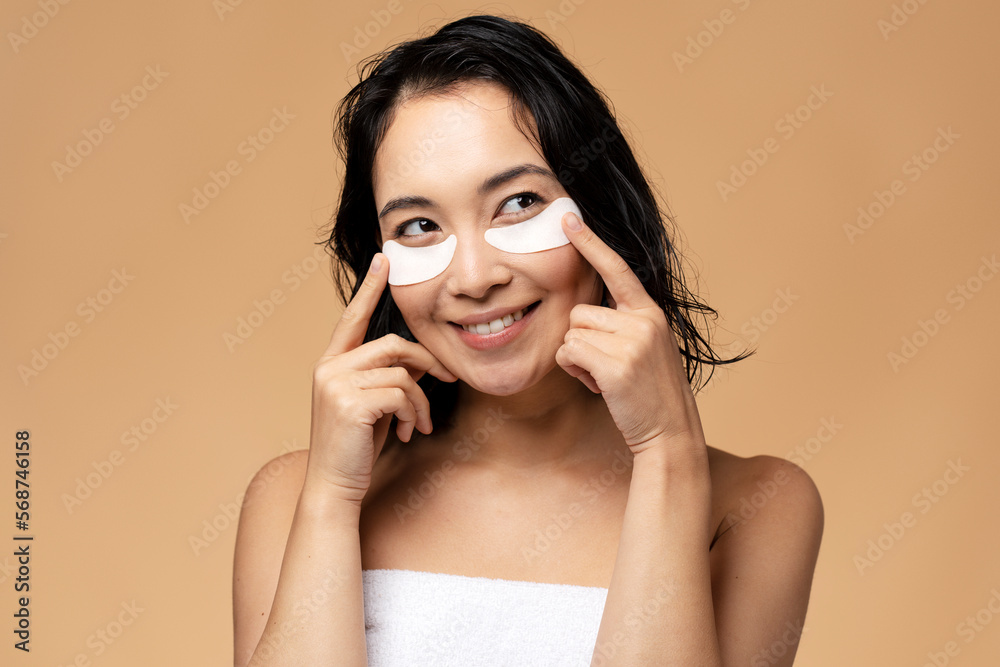 Close-up of asian girl with patches under eyes from swelling and wrinkles Close-up of asian girl with patches under eyes from swelling and wrinkles