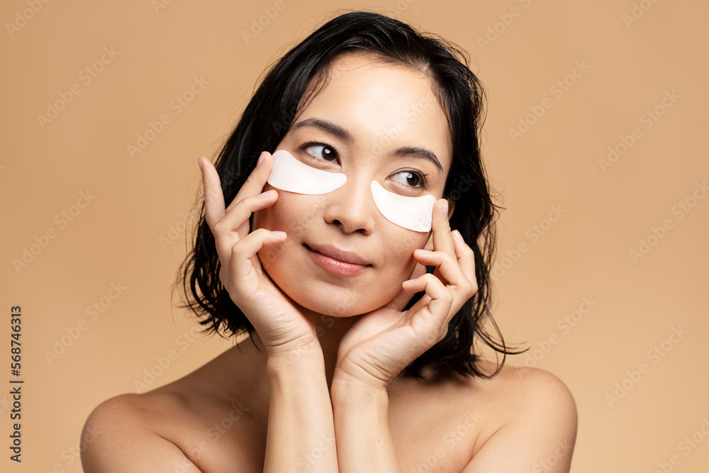 Eyes mask cosmetic woman face isolated on beige background Eyes mask cosmetic woman face isolated on beige background